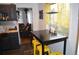 View from the kitchen to the dining area with stools, table, and living room in the background at 215 Colorado Blvd, Idaho Springs, CO 80452