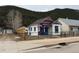 Quaint home featuring colorful accents, a small porch, and a charming American flag waving proudly at 215 Colorado Blvd, Idaho Springs, CO 80452