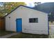 Detached garage with white siding, blue trim, and a side entrance at 215 Colorado Blvd, Idaho Springs, CO 80452