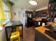 Cozy kitchen featuring dark cabinetry, butcher block counters, and a breakfast table with sunny yellow stools at 215 Colorado Blvd, Idaho Springs, CO 80452