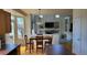 Dining room with large windows, an elegant table and view into the living room at 8024 W 95Th Way, Broomfield, CO 80021