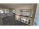Open carpeted hallway with white railings overlooking the living room at 8024 W 95Th Way, Broomfield, CO 80021