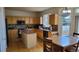 Bright kitchen featuring wooden cabinets, a center island, and modern appliances at 8024 W 95Th Way, Broomfield, CO 80021