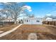 Spacious backyard with a concrete pathway leading to the house, fenced perimeter, and landscaping at 1780 S Umatilla St, Denver, CO 80223