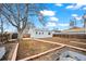 Large backyard with a shed, bordered by wooden fencing with a pathway that leads to the blue house at 1780 S Umatilla St, Denver, CO 80223