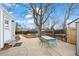 Inviting backyard patio featuring a table set perfect for outdoor dining and relaxation, surrounded by a wooden fence at 1780 S Umatilla St, Denver, CO 80223