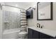 Updated bathroom with a decorative tile backsplash and modern vanity at 1780 S Umatilla St, Denver, CO 80223