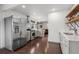 Well-lit kitchen featuring stainless steel appliances, wood floors and open access to the living area at 1780 S Umatilla St, Denver, CO 80223