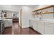 Open kitchen with stainless steel dishwasher, wood floors and open access to the living area at 1780 S Umatilla St, Denver, CO 80223