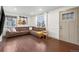Spacious living room with hardwood floors and large L shaped brown couch at 1780 S Umatilla St, Denver, CO 80223