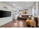 Modern living room showcasing hardwood floors, comfortable seating, and an adjacent kitchen at 1780 S Umatilla St, Denver, CO 80223