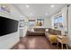 Open-concept living room featuring hardwood floors, cozy seating, and natural light at 1780 S Umatilla St, Denver, CO 80223