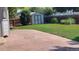 Well-maintained backyard with stamped concrete patio, storage shed, and lush lawn at 14558 Vine St, Thornton, CO 80602