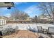 Backyard patio with seating area, snow-covered yard, string lights, and privacy fence at 14558 Vine St, Thornton, CO 80602