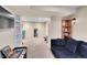 Finished basement featuring a TV, bookshelves, couch, and workout area at 14558 Vine St, Thornton, CO 80602