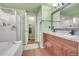 Spacious bathroom featuring a soaking tub, glass shower, and double vanity at 14558 Vine St, Thornton, CO 80602