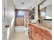 Well-lit bathroom featuring a tub/shower and vanity with warm colors at 14558 Vine St, Thornton, CO 80602
