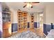 Inviting bedroom with custom shelving, wood floors, and a blue accent wall at 14558 Vine St, Thornton, CO 80602