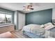 Bedroom with neutral paint, updated light fixture, and a window for natural light at 14558 Vine St, Thornton, CO 80602