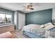 This bedroom features a ceiling fan, modern gray walls and hardwood-style floors at 14558 Vine St, Thornton, CO 80602