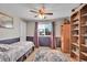 Comfortable bedroom with a ceiling fan, natural light from the window, and wood-look floors at 14558 Vine St, Thornton, CO 80602