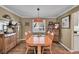 Cozy dining room with hardwood floors, crown molding, and a unique light fixture at 14558 Vine St, Thornton, CO 80602