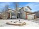 Charming two-story home with a brick facade and well-manicured front yard covered in winter snow at 14558 Vine St, Thornton, CO 80602