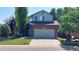 Charming two-story home with well-maintained lawn and a two car garage at 14558 Vine St, Thornton, CO 80602