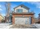 Two-story home with a brick front and a two-car garage, offering curb appeal and convenient parking at 14558 Vine St, Thornton, CO 80602