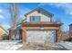 Attached two-car garage with brick veneer and updated doors, nestled under a classic gable roof at 14558 Vine St, Thornton, CO 80602