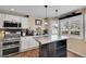 Well-equipped kitchen with stainless steel appliances and a center island at 14558 Vine St, Thornton, CO 80602