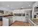 Contemporary kitchen with stainless steel appliances and hardwood floors at 14558 Vine St, Thornton, CO 80602