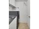 Functional laundry room with a stacked washer and dryer and convenient storage at 14558 Vine St, Thornton, CO 80602