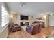 Cozy living room features a fireplace, hardwood floors, and comfortable leather seating at 14558 Vine St, Thornton, CO 80602