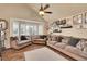 Comfortable living room featuring a large window, hardwood floors, and neutral-toned furniture at 14558 Vine St, Thornton, CO 80602