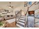Bright living room featuring hardwood floors, high ceilings, and a staircase at 14558 Vine St, Thornton, CO 80602