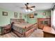 Inviting bedroom with wood furniture, ceiling fan, and unique wall décor at 14558 Vine St, Thornton, CO 80602