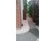 Gravel walkway along the side of a brick house leading to a wooden gate and backyard area at 14558 Vine St, Thornton, CO 80602