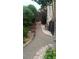 Gravel pathway with landscaping leading to a wooden gate and backyard area of the property at 14558 Vine St, Thornton, CO 80602