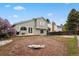 Spacious backyard featuring a lawn, patio, and exterior view of the two-story home at 8174 Field Cir, Arvada, CO 80005