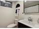 Clean bathroom featuring a vanity, toilet, framed mirror, and modern fixtures at 8174 Field Cir, Arvada, CO 80005
