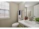 Well-lit bathroom with a window, sink with modern fixtures, and neutral decor at 8174 Field Cir, Arvada, CO 80005