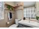 Bright bathroom featuring light wood shelving, blue vanity, and modern fixtures at 8174 Field Cir, Arvada, CO 80005