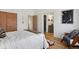 Bedroom boasts hardwood flooring, a comfortable bed, and an ensuite bathroom at 8174 Field Cir, Arvada, CO 80005