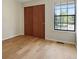 Empty bedroom featuring hardwood flooring, modern window fixtures, and a spacious layout at 8174 Field Cir, Arvada, CO 80005