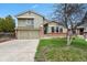 Charming two-story home featuring a well-maintained lawn, brick accents, and an attached two-car garage at 8174 Field Cir, Arvada, CO 80005