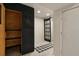Hallway featuring access to a sauna, modern tile flooring, and a stylish black barn door at 8174 Field Cir, Arvada, CO 80005