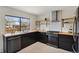 Modern kitchen with stainless steel appliances, stylish backsplash, and plenty of counter space at 8174 Field Cir, Arvada, CO 80005
