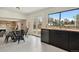 Bright kitchen and dining area with stainless appliances and large windows overlooking the backyard at 8174 Field Cir, Arvada, CO 80005
