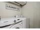 Laundry area with modern Samsung washer and dryer units, featuring a decorative sign at 8174 Field Cir, Arvada, CO 80005
